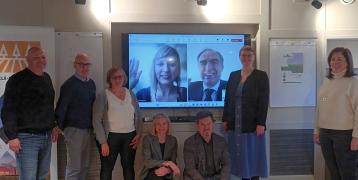 Project partners gathered for a group photo in a meeting room